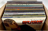 Cardboard box filled with multiple vinyl records showing the front cover of Eric Burdon and The Animals album