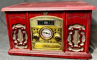 Front view of nostalgic style Memorex turntable unit with red wood finish, gold trim, speaker grills, and controls
