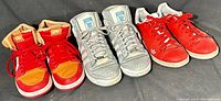 Three pairs of men's sneakers: Nike Air Jordan 1, Adidas Top Ten Hi Star Wars Obi Wan Kenobi, and Adidas Stan Smith red/white.