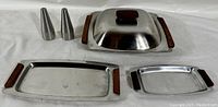 Full view of entire lot showing two trays, covered serving dish, and two shakers