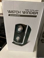 Front view of the boxed Time Tutelary automatic double watch winder showing two watch slots and branding.