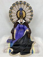 Front view of the Evil Queen figurine seated on throroughly detailed throne with peacock back