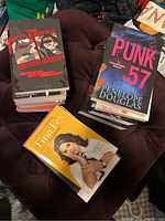 Top view of multiple books including The Battle Royale Slam Book, Punk 57 by Penelope Douglas, and Bossypants by Tina Fey