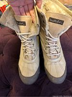 Top view of Wind River winter boots showing brand label on tongue and lace-up front.