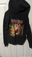 Back view of black zip-up hoodie showing large full-color horror movie graphic: Silent Night Deadly Night Part 2