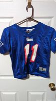 Front view of the blue NFL Buffalo Bills Steve Bledsoe #11 football jersey showing team logo and number on chest.