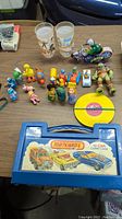Full overview of lot including figurines, toys, and Matchbox carry case