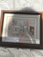 Framed print titled 'Hearthside Afternoon' by Helen Downing Hunter showing a colorful interior scene with a fireplace and furniture.