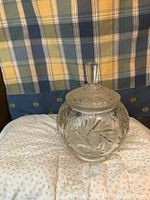 Clear large vintage crystal candy bowl with ornate cut glass design and a matching lid with faceted handle.