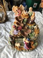 Photo showing all nativity figures arranged on detailed base with stepped layers and hay effects.