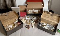 Overview box lot with multiple plastic or resin vintage Christmas ornaments including angels, reindeer, snowman and Santa heads.
