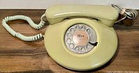 Side and front view of the vintage beige rotary dial phone displaying rotary dial and handset