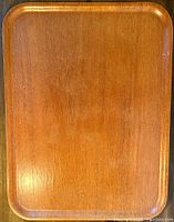 Top-down view showing the full rectangular teak tray with rounded corners and smooth finish.