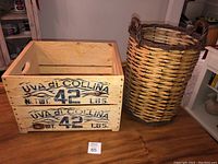 Photo showing the wooden crate and wicker basket side by side on a wooden surface.