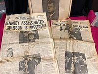 Two original Globe & Mail newspapers from Nov 1963 laid out side by side showing front pages with headlines about Kennedy assassination and Oswald slaying.