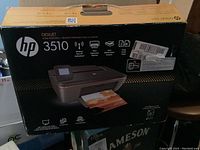 Original packaging box showing HP Deskjet 3510 model and printer features. Box is intact with some shipping labels.