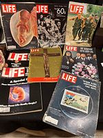 Seven Life Magazine special issues from 1950s, 1960s, and 1980 displayed together on a table, showing varied historical and cultural themes.