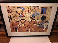 Framed Joan Miro print from a front angle showing overall condition including frame wear and stain on print.