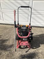 Front view of the Homelite gas power washer showing the frame, handle, and attached spray wand.