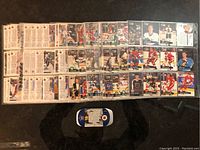 Hockey trading cards spread out on a surface, showing both front and back of cards.