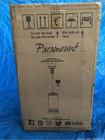 Sealed cardboard box with Paramount branding and line drawing of assembled heater