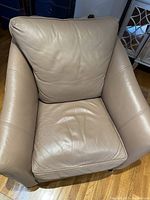 Front view of a single Ethan Allen custom leather armchair showing deep cushioned seat and back cushions in beige leather