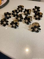 Set of 11 napkin rings arranged on a flat surface, showing the design and quantity.