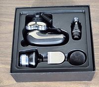 Top view of the grooming kit with all interchangeable heads in a black molded holder inside box.
