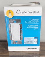 Front view of the Lutron Caséta Wireless dimmer packaging featuring product image and key feature indicating it works for wall and ceiling lights.