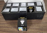 Open box showing all 10 individual Dicuno LED bulb packages with product labels visible.