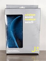 Blue wireless Bluetooth headphones in original packaging with window showing headphones.