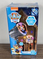 Front image of boxed Paw Patrol Whirl-A-Motion + Static Lightshow Projection Plus showing the colorful projection lens and Paw Patrol characters.