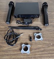 Top view of all components including receiver, two mics, antennas, adapters, power cable, and clips