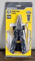 Front view of packaged Workpro 12-in-1 multi tool showing tool handles, part of the fold-out tools, and included pouch inside the packaging.