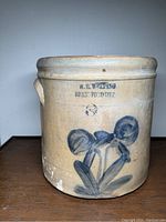 Front view of large beige stoneware crock with blue flower design, marked W.E. Welding Brantford Ontario and size 3.