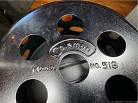 Close-up photo of the heater's top showing embossed Coleman logo and Model No. 518.