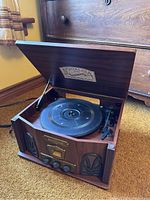 Front angled view of TEAC Nostalgia record player with lid open, showing turntable and wood finish.