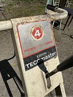 Close-up of the shifter control on the handle with power reverse label and Eaton Tecomaster branding.