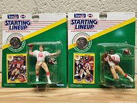 Both figures in original packaging side by side, showing front view with card backing and figures.