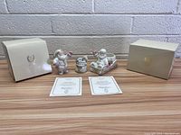 Two Lenox Santa Claus figurines and a small carousel-like decorative horse piece, with original boxes and certificates.