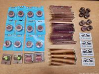 Full overview of the makeup items laid out on a table, showing eyeshadows, eyeliner pencils, blushes, and eyelid jewels.