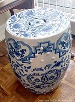 Side top angle showing floral and geometric patterns on the plant stand surface.