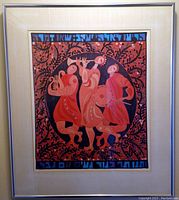 Photo of a framed art piece showing three musicians in abstract style with red and orange tones, beige mat, and silver frame.