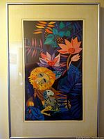 Framed lithograph artwork featuring a lion and floral design in a silver frame.