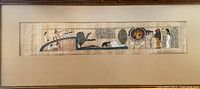 Framed lithograph artwork featuring Egyptian figures and hieroglyphs, displayed horizontally.