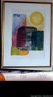 Full view of the framed lithograph showing colorful abstract geometric shapes with sun-like circle in upper right.
