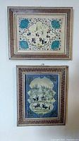 Set of two framed Asian art pieces hung on a wall, showing both artworks together.