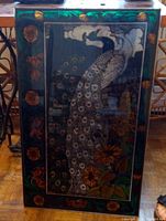 Full front view of stained glass panel depicting a peacock with floral border