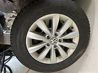 Silver multi-spoke Volkswagen alloy rim with mounted Continental tire