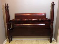 Full view of the mahogany headboard and footboard arranged together showing posts, panels, and finials.